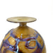 Glass vase with purple and gold swirls on a white background