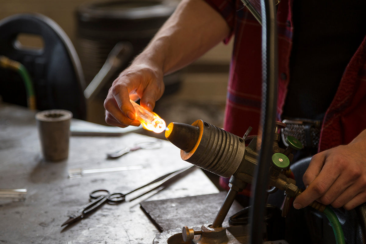 glassblower working at a torch, lampworking, flameworking photo by Owen Colborne